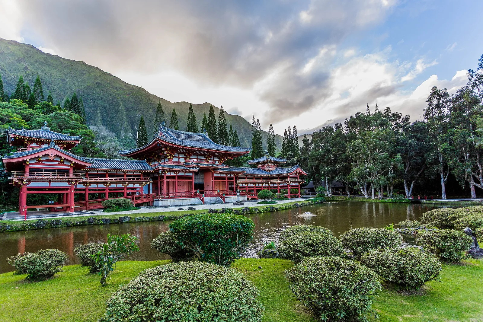 The red Byodo-In Temple and its reflecting pond beneath the Koolau mountains in Kaneohe
