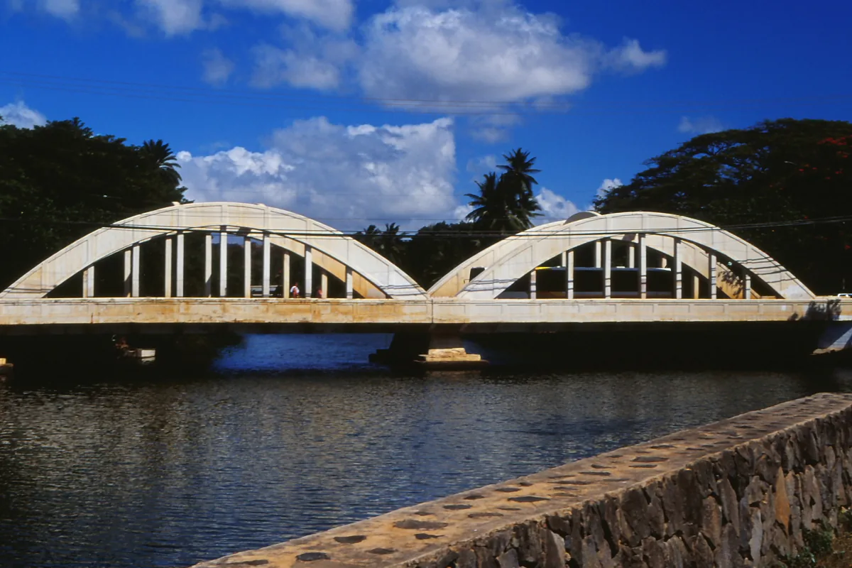 The double-arched Anahulu Stream bridge at Haleiwa under a blue sky
