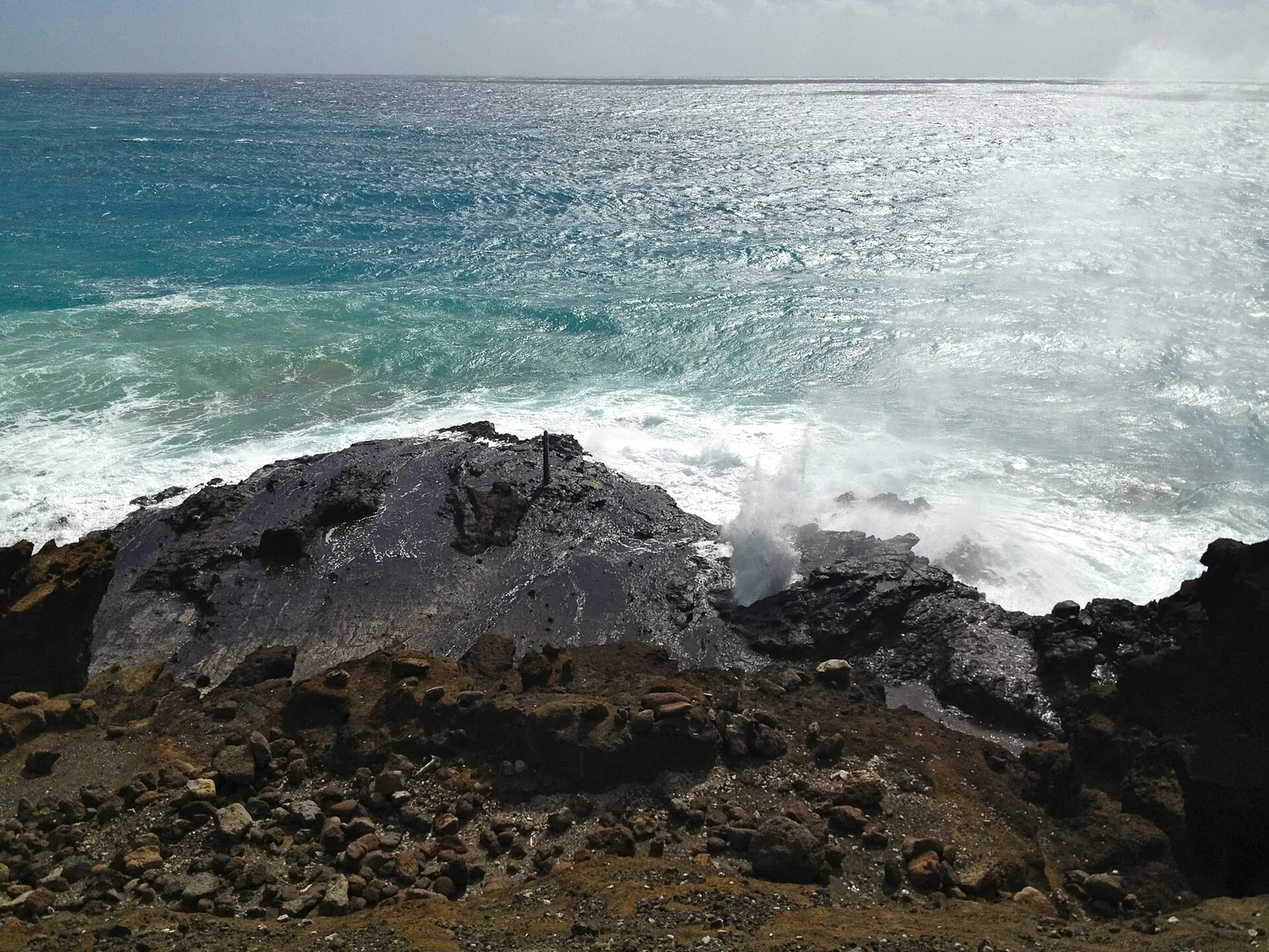 Waves spraying through the lava rock at the Halona Blowhole on Oahu's southeast coast