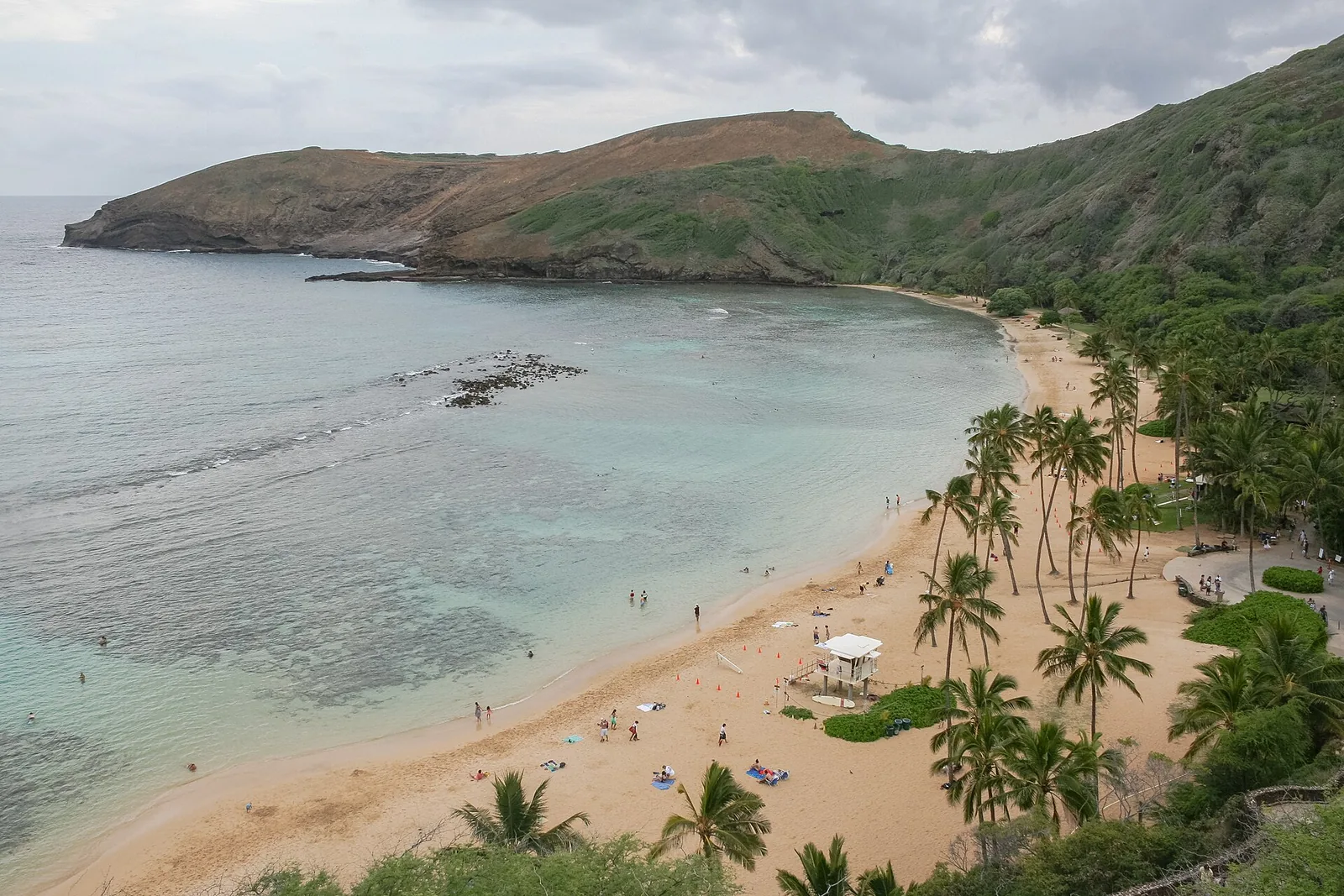 Hanauma Bay's curved beach and shallow reef inside a volcanic crater on Oahu's southeast shore