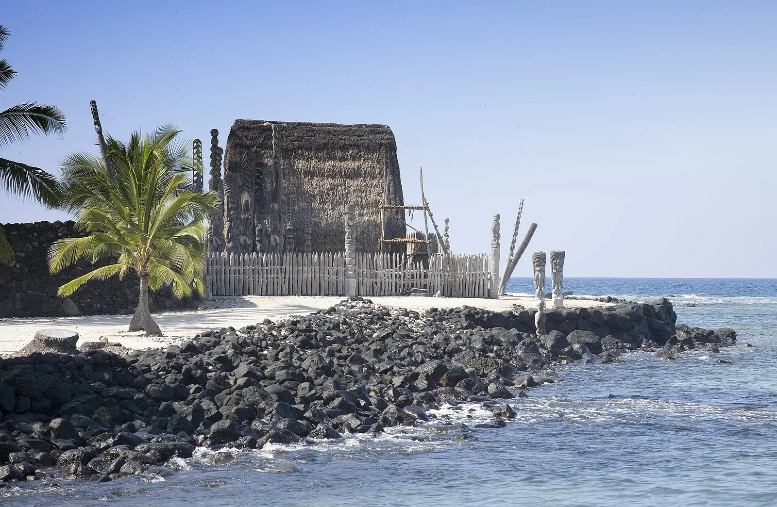 The reconstructed thatched temple and carved wooden kii images at Puuhonua o Honaunau