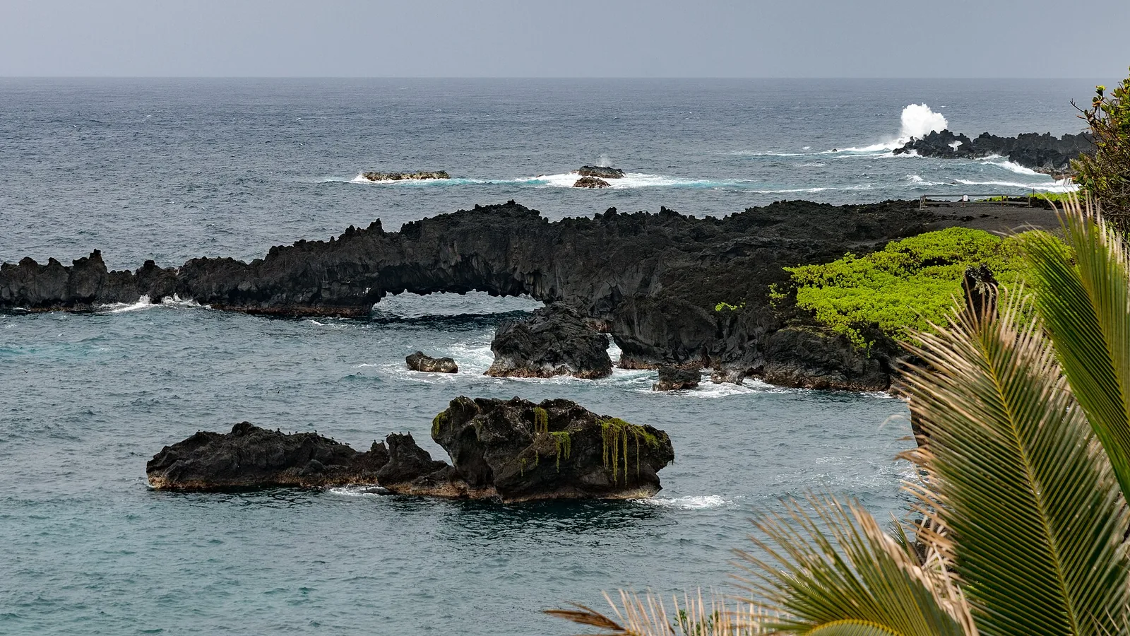 A natural lava arch on the black lava coast at Waianapanapa State Park on Maui