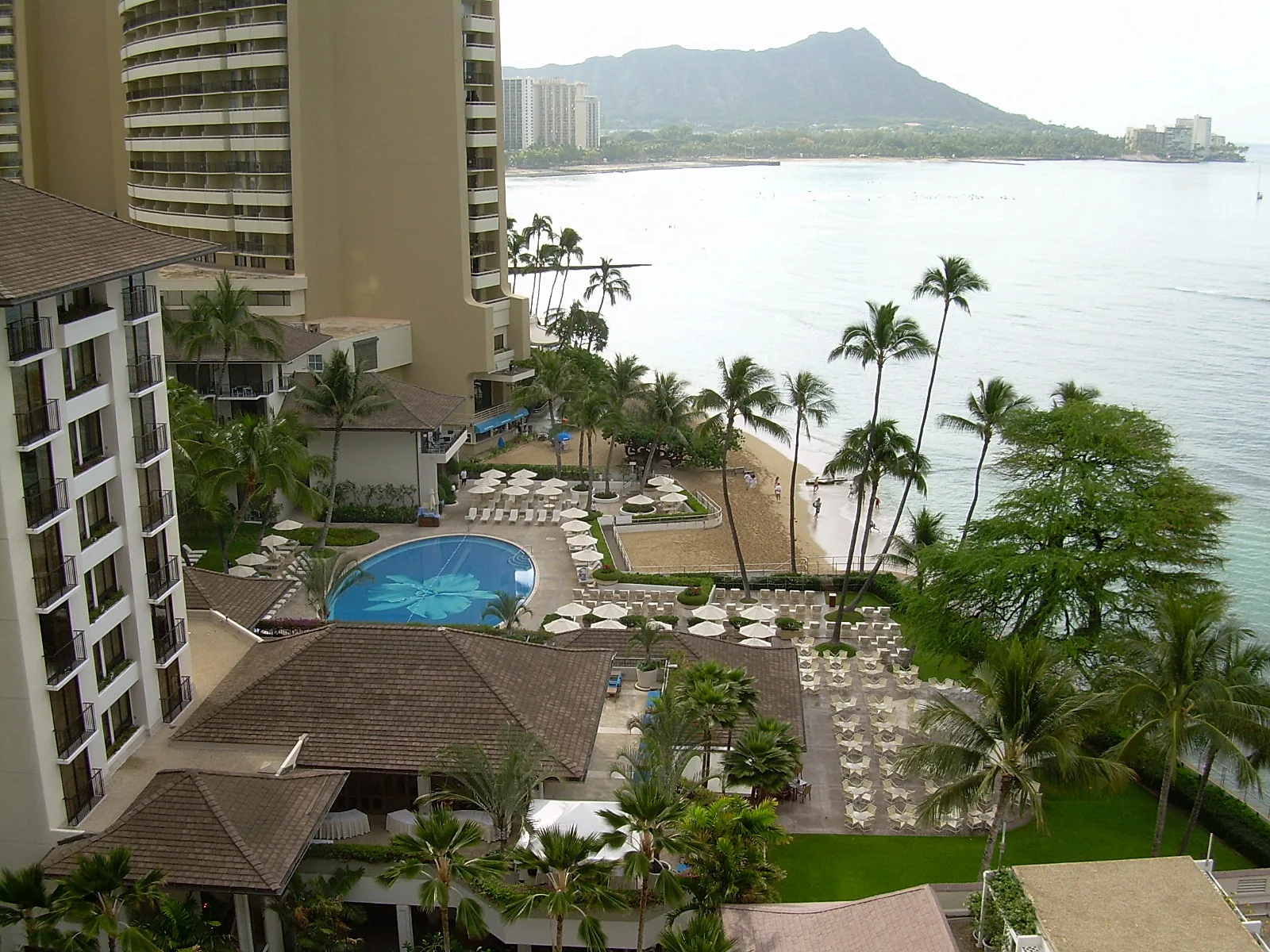 The Halekulani hotel pool and gardens on Waikiki Beach with Diamond Head in the distance