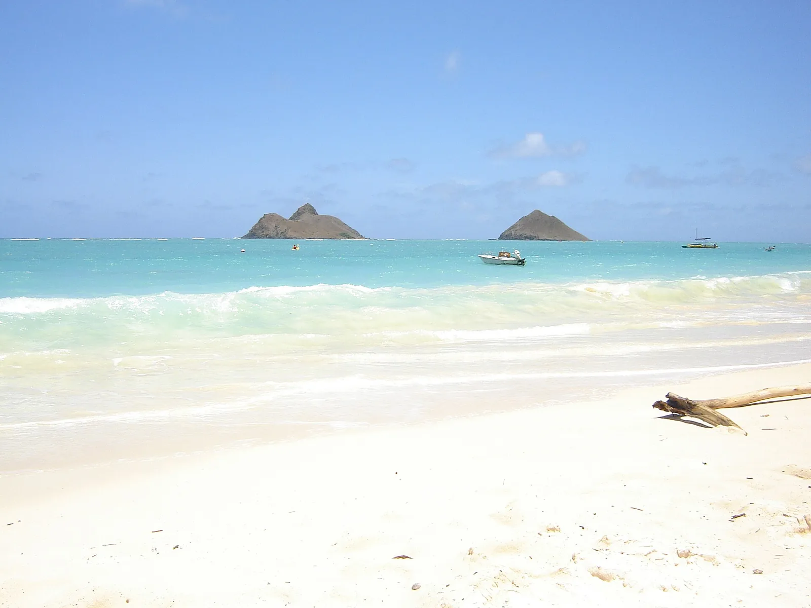 White sand and clear turquoise water at Lanikai Beach with the two Mokulua islets offshore