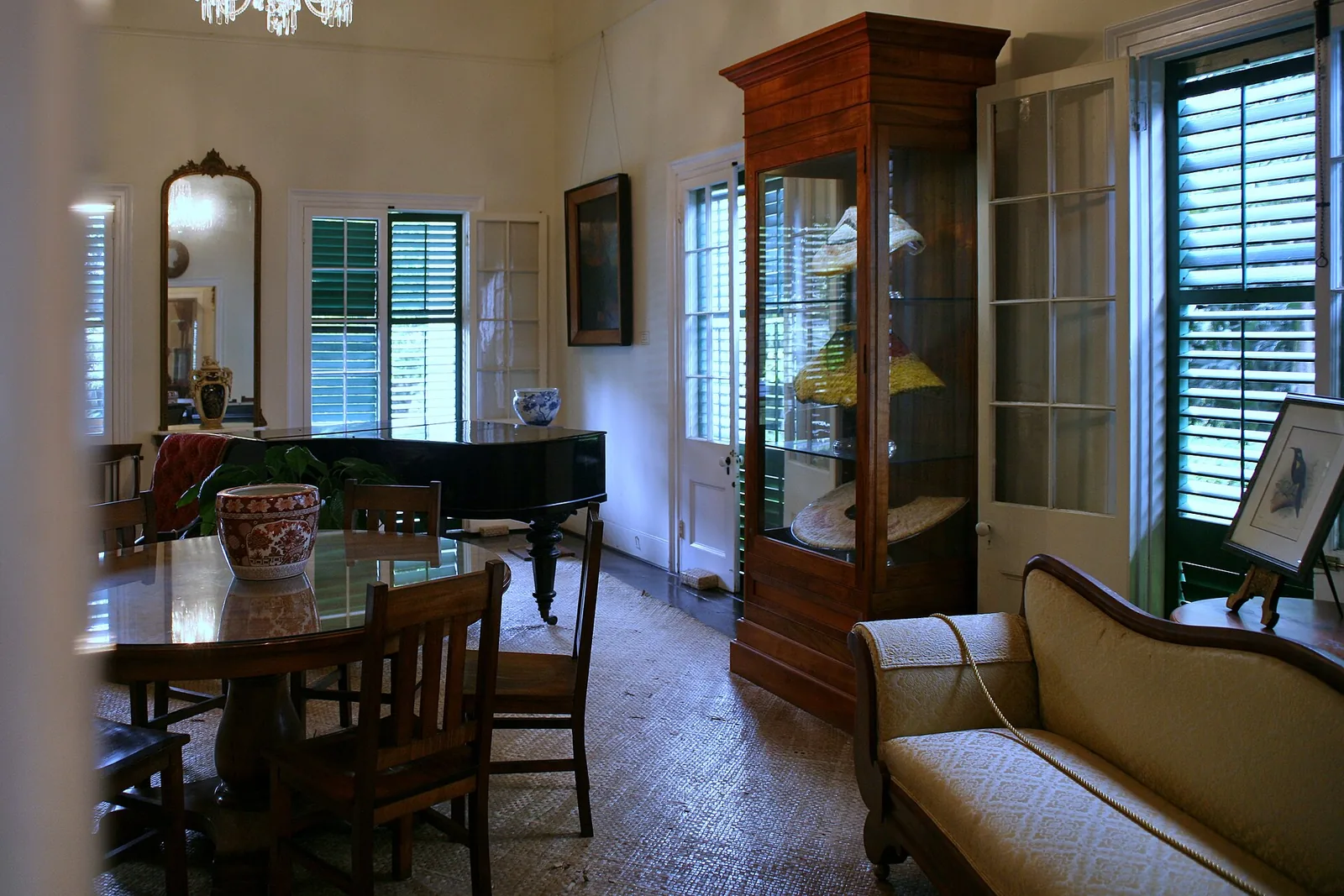 The parlour of Queen Emma Summer Palace with koa furniture, a piano and display cases