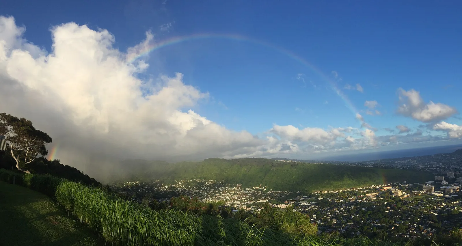 A rainbow arching over Manoa Valley and Honolulu after a passing shower on Oahu