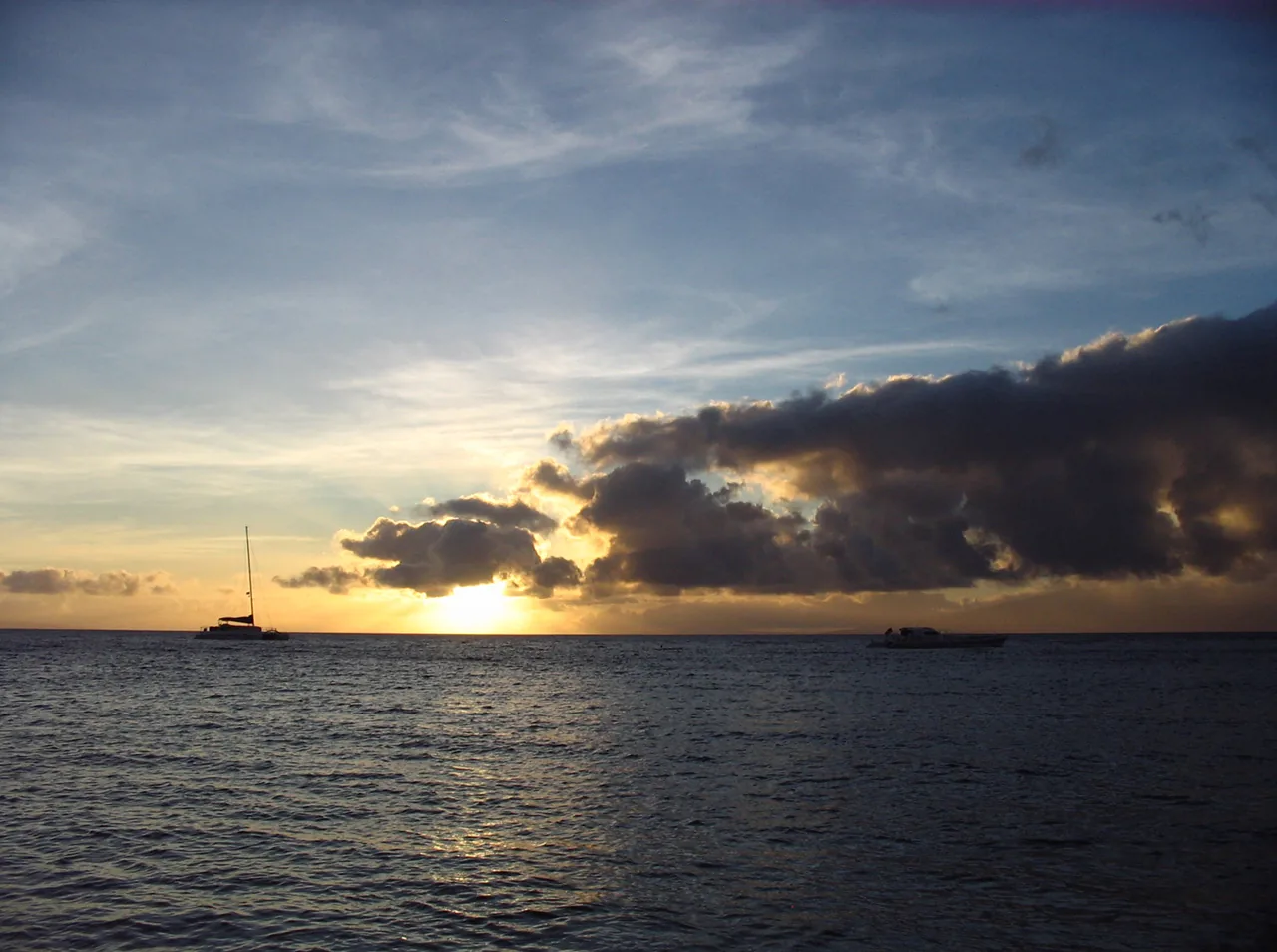 A sailing catamaran silhouetted against the sunset off Kaanapali on Maui