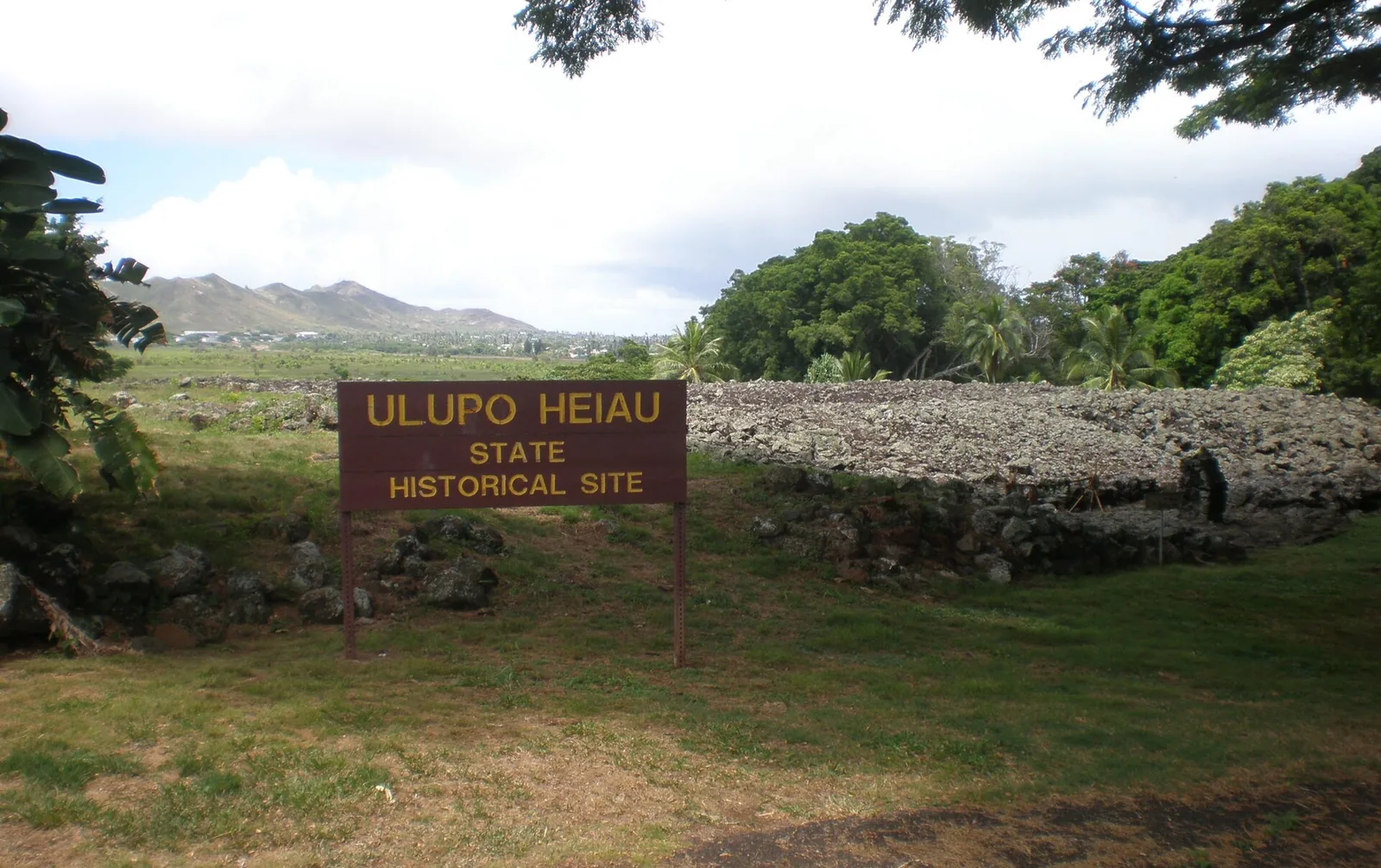 The Ulupo Heiau State Historical Site sign in front of the stone temple platform in Kailua